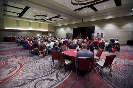 Guests sitting at tables in a ballroom during the military social