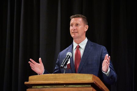 Speaker for military social event speaking at a podium 